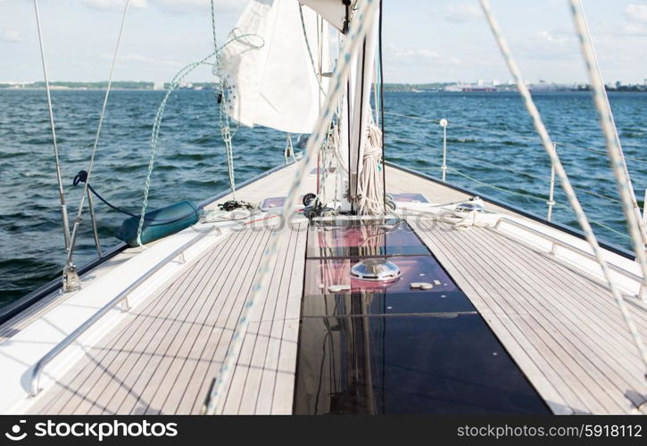 vacation, travel, cruise and leisure concept - close up of sailboat or sailing yacht deck and sea