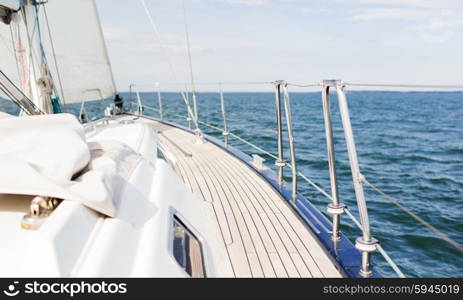 vacation, travel, cruise and leisure concept - close up of sailboat or sailing yacht deck and sea