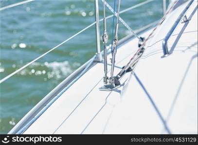 vacation, travel, cruise and yachting concept - close up of cable on sailboat or sailing yacht deck and sea. close up of sailboat or sailing yacht deck in sea