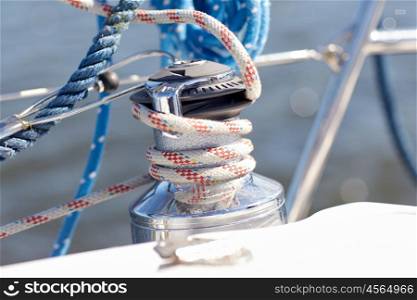 vacation, travel, cruise and yachting concept - close up of mooring rope on sailboat or sailing yacht deck and sea