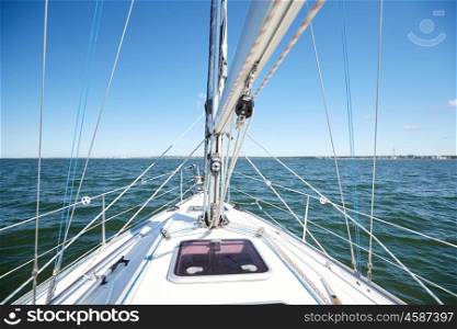 vacation, travel, cruise and yachting concept - close up of sailboat or sailing yacht deck and sea