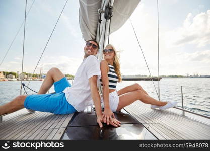 vacation, travel, sea, friendship and people concept - smiling couple sitting and talking on yacht deck