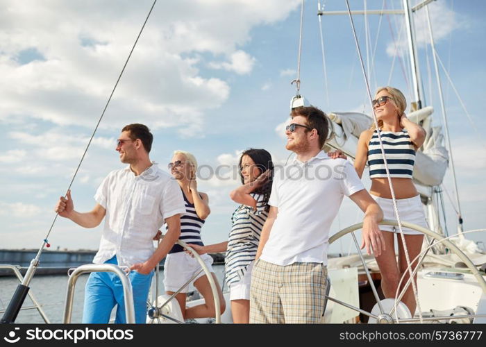 vacation, travel, sea, friendship and people concept - smiling friends sailing on yacht