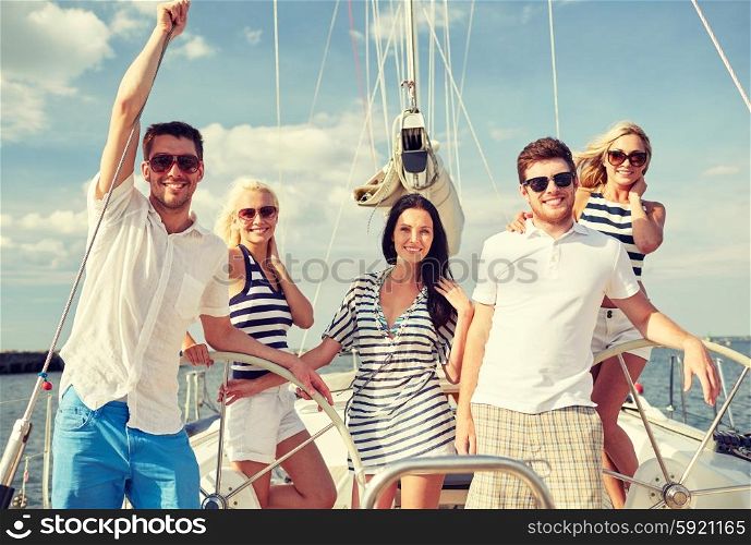 vacation, travel, sea, friendship and people concept - smiling friends sailing on yacht