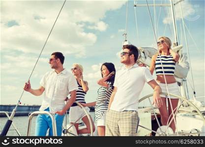 vacation, travel, sea, friendship and people concept - smiling friends sailing on yacht
