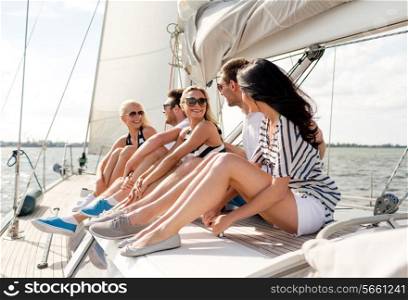 vacation, travel, sea, friendship and people concept - smiling friends sitting on yacht deck