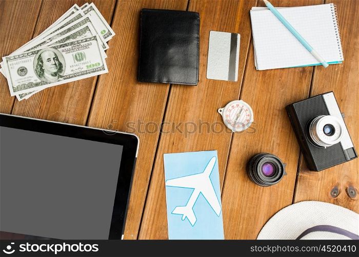 vacation, travel, tourism, technology and objects concept - close up of gadgets and traveler personal stuff