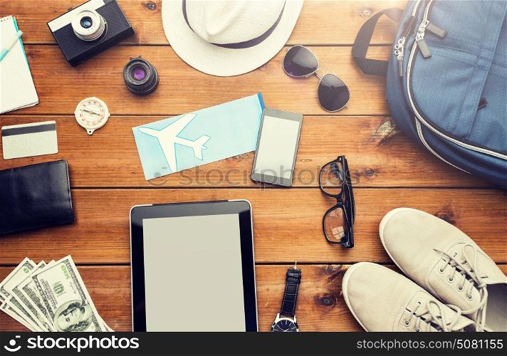 vacation, travel, tourism, technology and objects concept - close up of gadgets and traveler personal stuff. close up of gadgets and traveler personal stuff