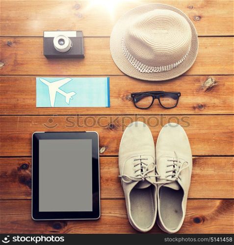 vacation, travel, tourism, technology and objects concept - close up of gadgets and traveler personal stuff. close up of gadgets and traveler personal stuff