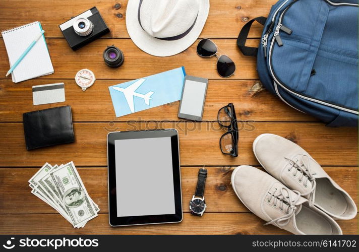 vacation, travel, tourism, technology and objects concept - close up of gadgets and traveler personal stuff