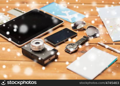 vacation, travel, tourism, technology and objects concept - close up of smartphone and personal stuff