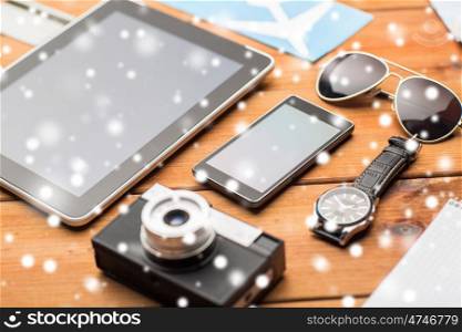 vacation, travel, tourism, technology and objects concept - close up of smartphone and personal stuff