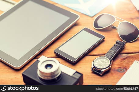 vacation, travel, tourism, technology and objects concept - close up of smartphone and personal stuff. close up of smartphone and travel stuff. close up of smartphone and travel stuff