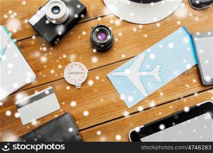 vacation, travel, tourism, winter holidays and objects concept - close up of camera and traveler personal stuff