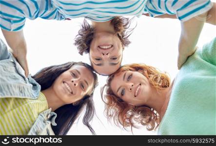 vacation, weekend, leisure and friendship concept - smiling happy young women or teenage girls on city street
