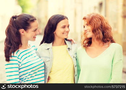 vacation, weekend, leisure and friendship concept - smiling teenage girls on street