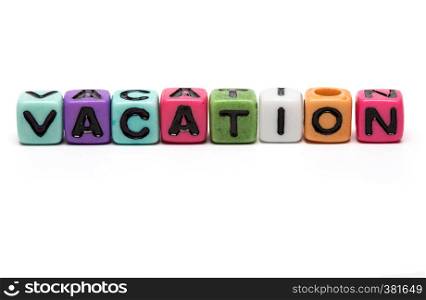 vacation - word made from multicolored child toy cubes with letters