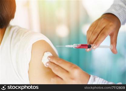 Vaccination of children by injection needle nurses are vaccinations to patients using the syringe in hospital / Doctor giving patient vaccine in arm of asian child girl healthy and medical concept