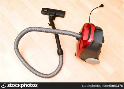 Vacuum cleaner on the wooden floor