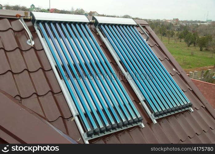 Vacuum solar water heating system on the house roof.