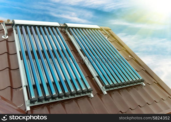 Vacuum solar water heating system on the house roof.