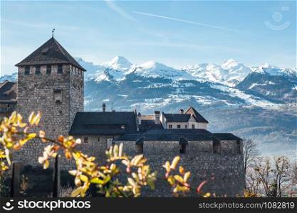 Vaduz castle, the palace and official residence of the Prince of Liechtenstein on snow mountains background