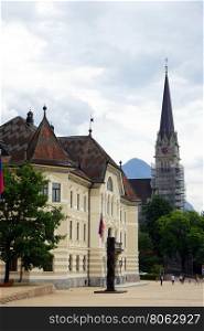 VADUZ, LICHTENSTEIN - CIRCA JULY 2016 Palace and church on the main street
