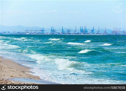 Valencia beach of El Saler with port cranes view in background at Spain