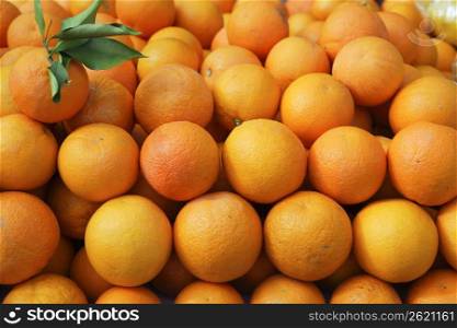 Valencia oranges stacked on market in mediterranean spain
