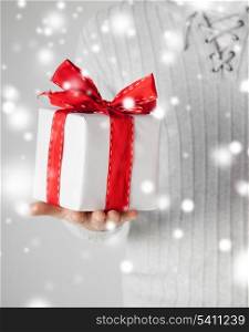valentine&#39;s day, christmas, x-mas, winter, happiness concept - man holding a gift box