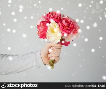valentine&#39;s day, christmas, x-mas, winter, happiness concept - young man holding bouquet of flowers