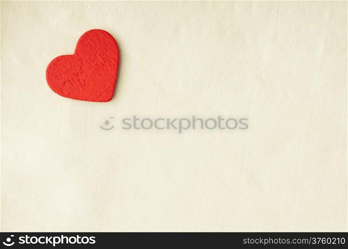 Valentine&#39;s day or wedding. Red wooden decorative heart on abstract white cloth textile background with copy space