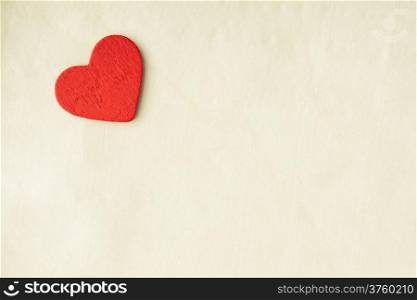 Valentine&#39;s day or wedding. Red wooden decorative heart on abstract white cloth textile background with copy space