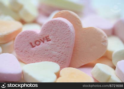 Valentine candy heart with the word love, in pink