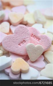 Valentine candy hearts in sweet colors, yes love