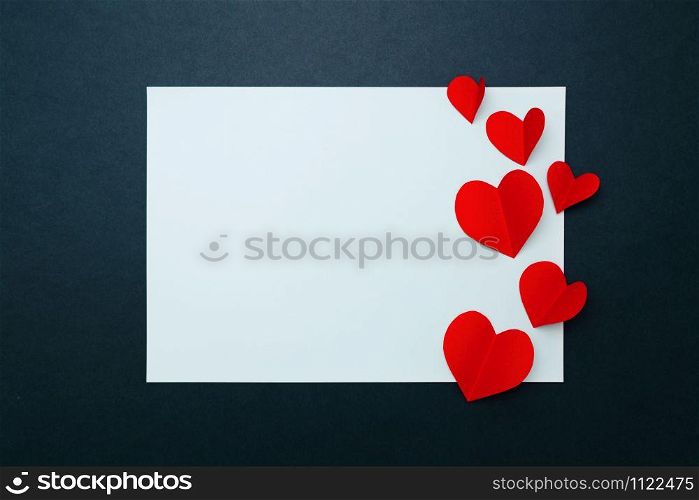 Valentine card with red heart on blue paper frame, flat lay, top view
