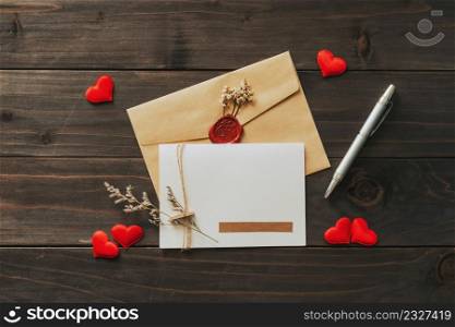 Valentine card with red heart on wooden background