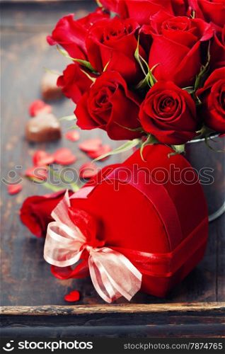 Valentine composition with roses and gift box over white