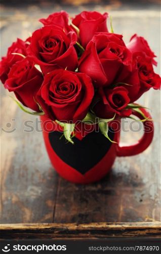 Valentine composition with roses on wooden background