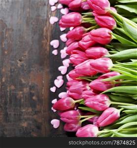 Valentine composition with tulips on wooden background