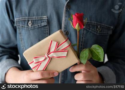 Valentine concept, Man hand holding red rose and gift box