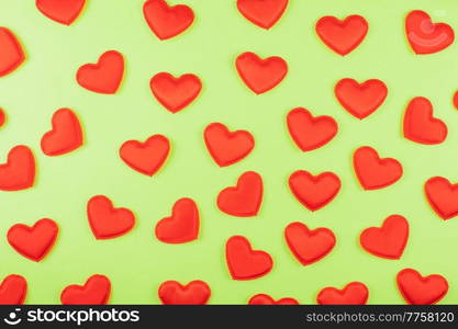 Valentine day green paper background with red hearts background. Valentines day or love concept. Valentine day green paper background