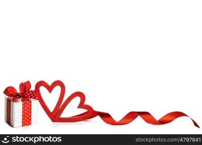 Valentine day hearts and gift. Two wooden red painted Valentine day hearts and gift box isolated on white background