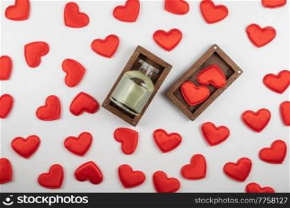 Valentine day white wood background with gift box with home aroma fragrance diffuser with red hearts. Valentines day gift or love concept. Valentine day white wood background