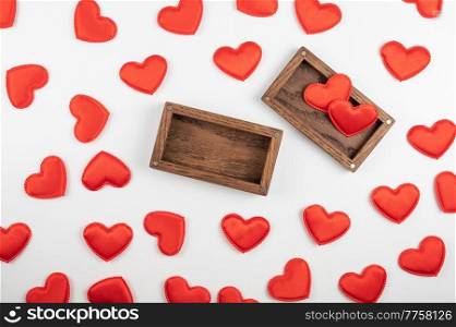 Valentine day white wood background with gift box with red hearts. Valentines day or love concept, copy space. Valentine day white wood background with gift box with red hearts
