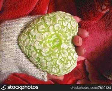 Valentine heart and heart shape candle in woman hand