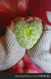 Valentine heart and heart shape candle in woman hands