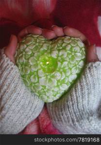 Valentine heart and heart shape candle in woman hands