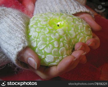 Valentine heart and heart shape candle in woman hands