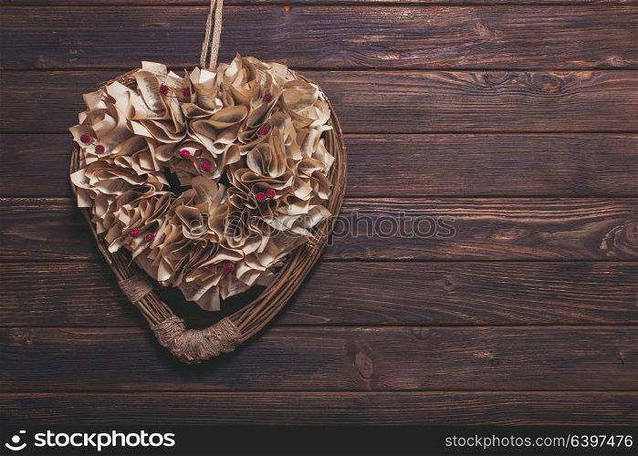 Valentine heart old book pages decoration on the wooden wall. Valentine heart decoration